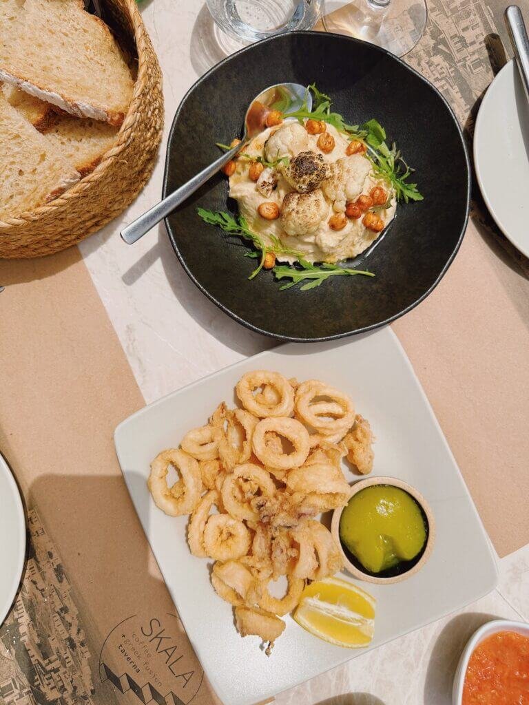 seafood and dip on a black plate in Greece