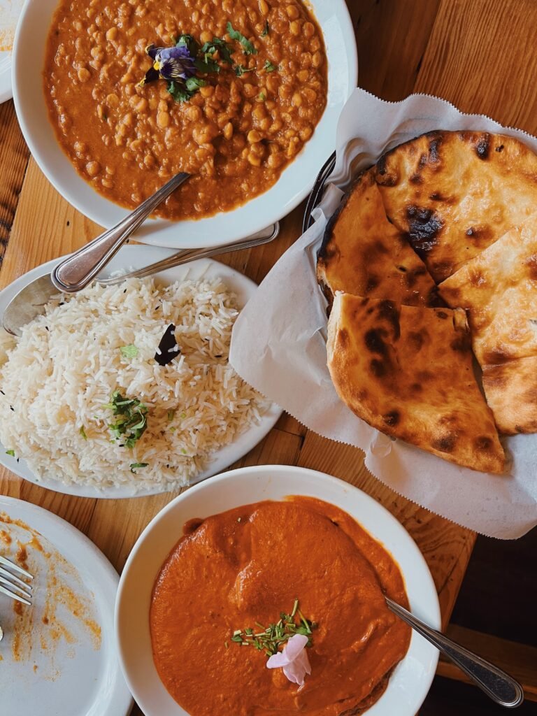 Indian food in Portland, Oregon. Rice, naan, curry and plates