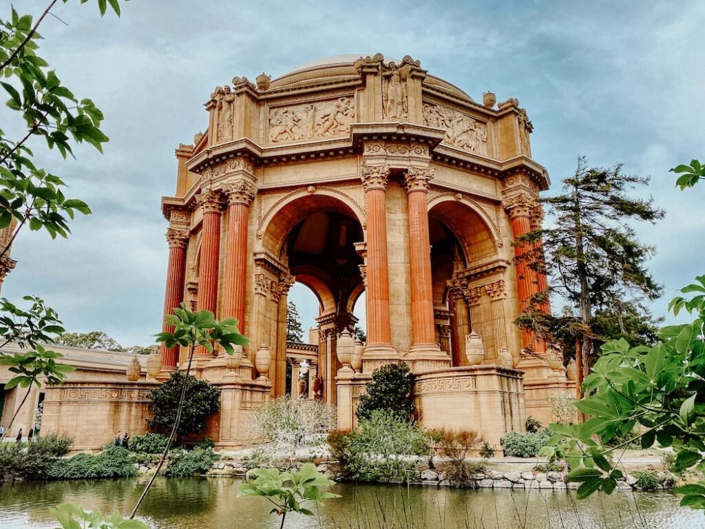 The grand architecture of the Palace of Fine Arts, with its towering columns and domed rotunda reflected in the surrounding lagoon.