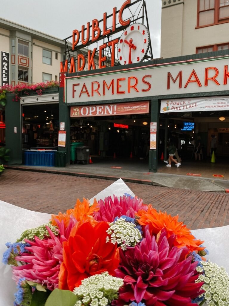 Pikes Place Market in seattle sign featuring the iconic flower bouquet