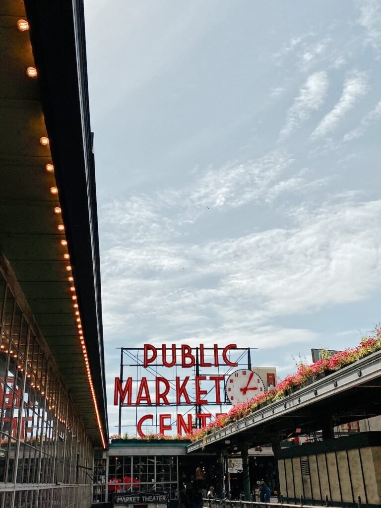 The iconic red neon sign at Pike Place Market in Seattle, a must-visit spot for food lovers and first-time visitors