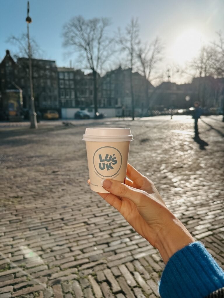 Coffee from Luuk's in Amsterdam, enjoyed on a sunny day, with a pastry from Bunbun—a perfect spring treat in the city.
