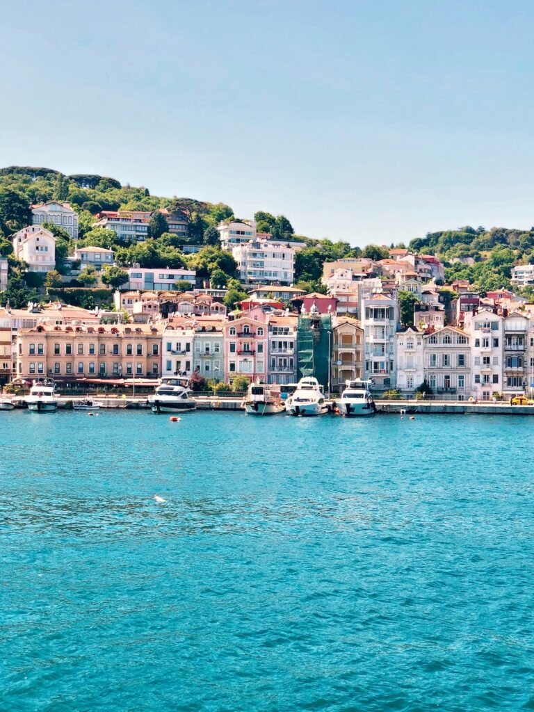 A scenic coastal view of white and brown historic buildings overlooking the sea, capturing the charm of a Mediterranean destination. Perfect for exploring Top European Destinations for Spring Travel with breathtaking waterfront landscapes. (Photo by Despina Galani on Unsplash)